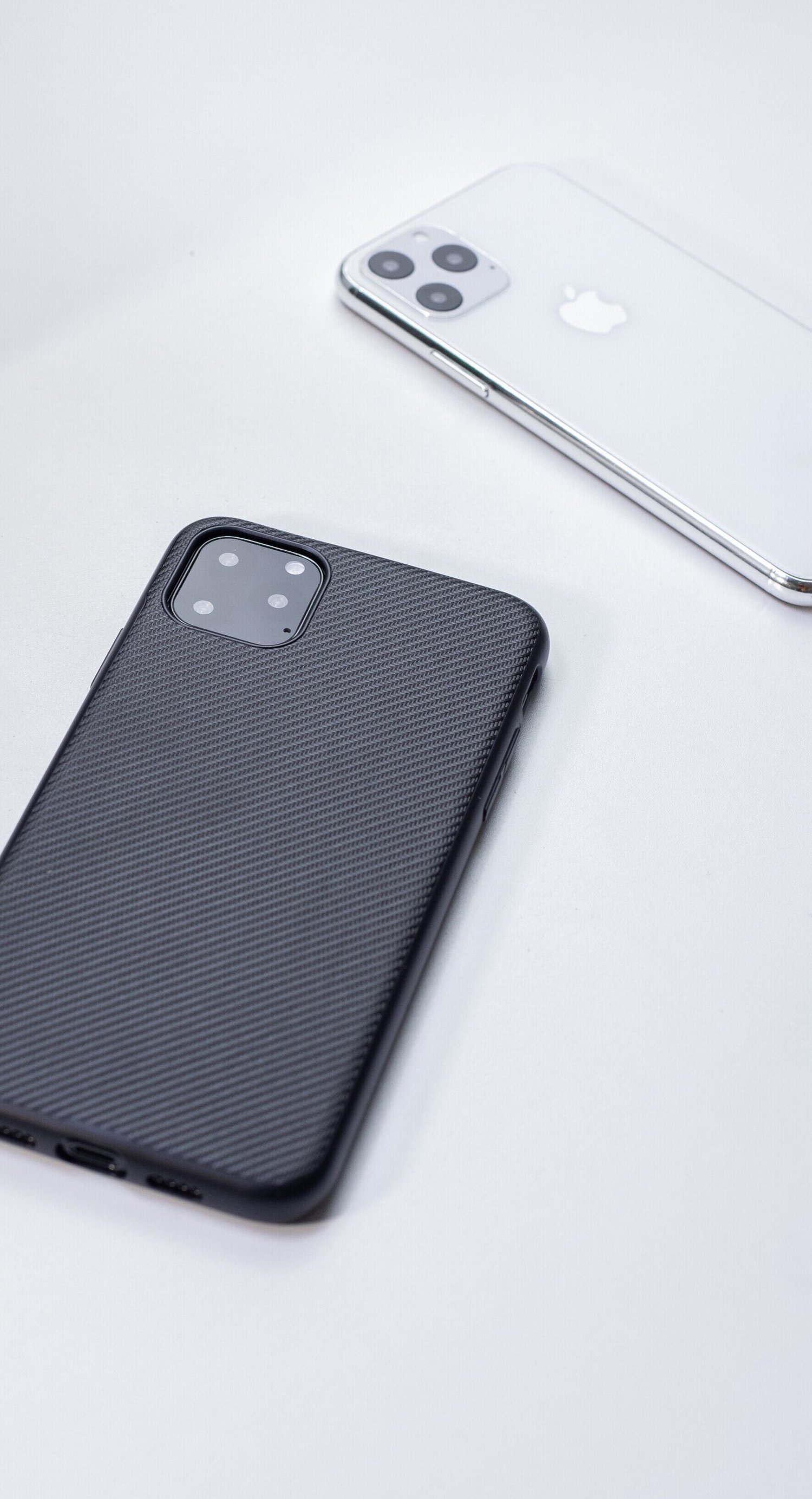 Two smartphones on a light surface